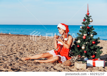 girl Christmas tree in the South on the beach 60291237