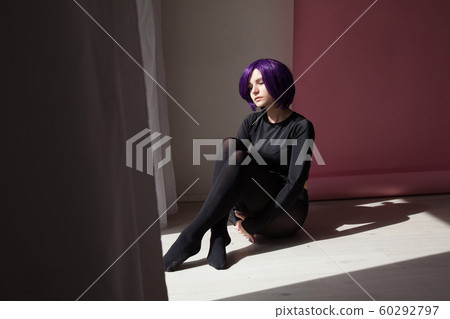Beautiful woman anime cosplayer with purple hair in black fashion clothes Beautiful woman anime cosplayer with purple hair in black fashion clothes 60292797