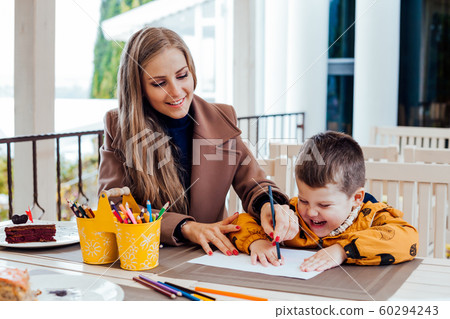 mom helps son to draw drawing colored pencils mom helps son to draw drawing colored pencils 60294243