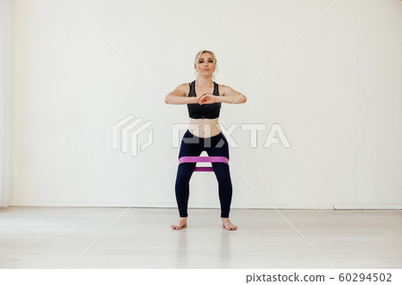 Blonde woman engaged in fitness with fitness gum 60294502