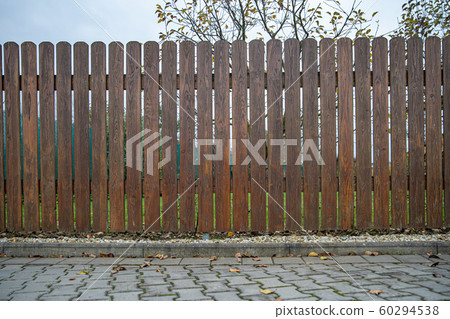 wooden fence in front of green garden of family house wooden fence in front of green garden of family house 60294538