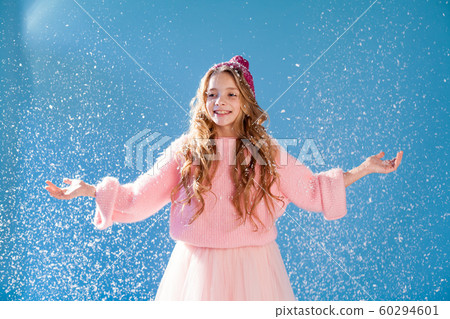 Beautiful fashionable girl in winter snow cap blue background Beautiful fashionable girl in winter snow cap blue background 60294601