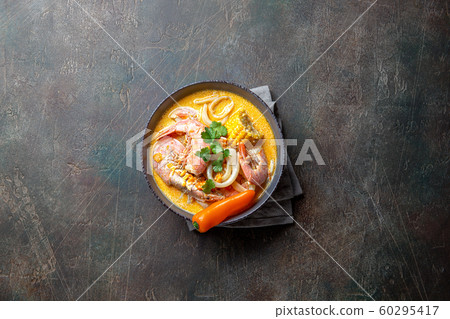 Peruvian seafood soup Chupe de Camarones in gray bowl, top view 60295417