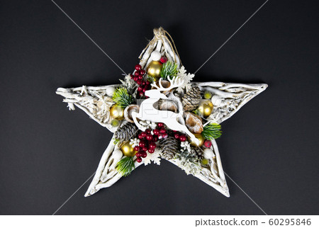 Handmade star decorated with cones and cranberries 60295846