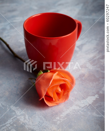 Rose with red empty mug on desk Rose with red empty mug on desk 60297247