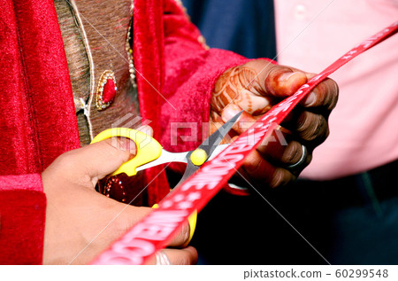 Cutting Ribbon in Indian Wedding Ritual Welcome Cutting Ribbon in Indian Wedding Ritual Welcome 60299548