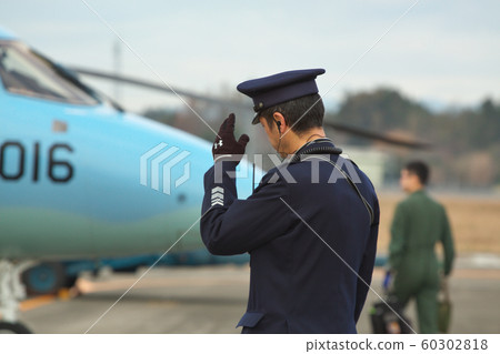Self-defense officers raising hands at the airbase 60302818