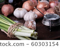 Fresh onion and garlic on wood plate 60303154