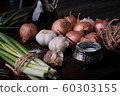 Fresh onion and garlic on wood plate 60303155