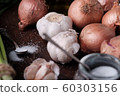 Fresh onion and garlic on wood plate 60303156