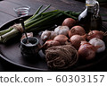 Fresh onion and garlic on wood plate 60303157
