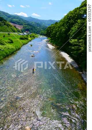 Kesenn River in summer crowded with sweetfish fishing. Rikuzentakata, Iwate, Japan. Early July. Kesenn River in summer crowded with sweetfish fishing. Rikuzentakata, Iwate, Japan. Early July. 60303297