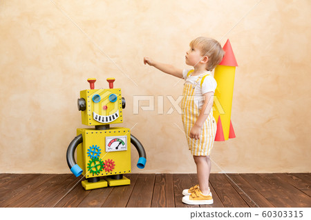 Happy child with toy robot 60303315