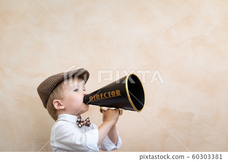 Child shouting through vintage megaphone Child shouting through vintage megaphone 60303381
