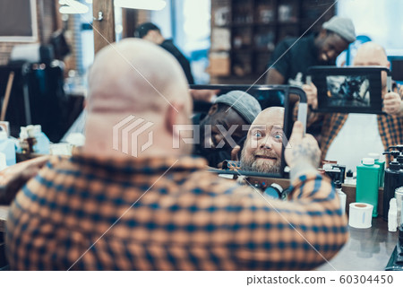 Master and exited client looking at mirror together Master and exited client looking at mirror together 60304450