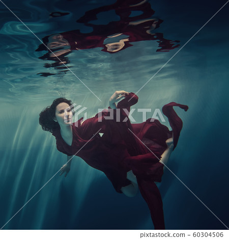 Portrait of a girl in a red dress under water Portrait of a girl in a red dress under water 60304506