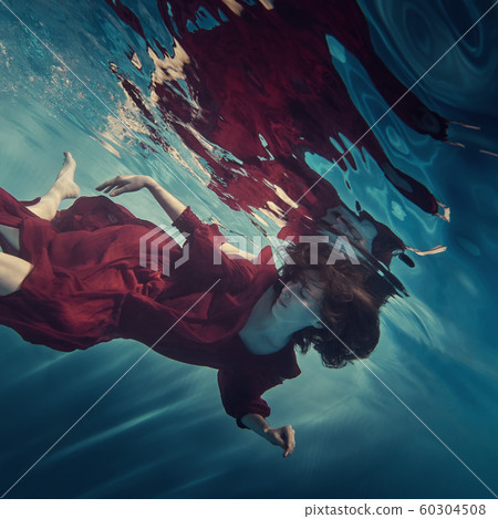 Portrait of a girl in a red dress under water Portrait of a girl in a red dress under water 60304508