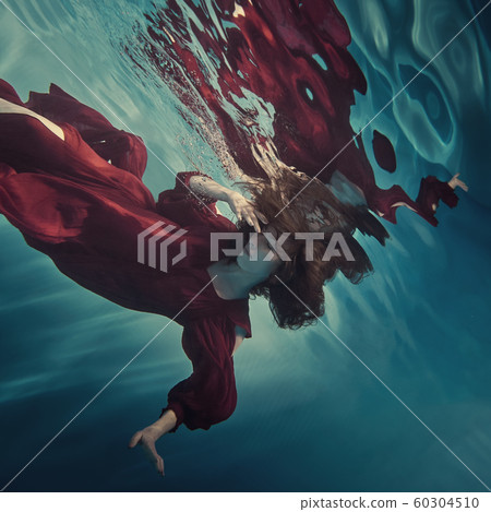 Portrait of a girl in a red dress under water Portrait of a girl in a red dress under water 60304510