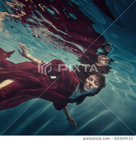 Portrait of a girl in a red dress under water Portrait of a girl in a red dress under water 60304513