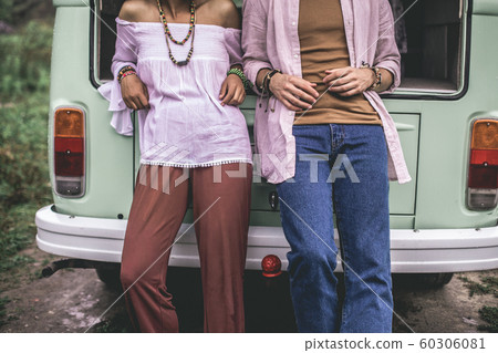 Close up of man and woman lean on retro van Close up of man and woman lean on retro van 60306081