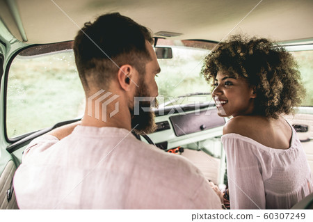 Beloved hippie couple travelling in retro bus Beloved hippie couple travelling in retro bus 60307249