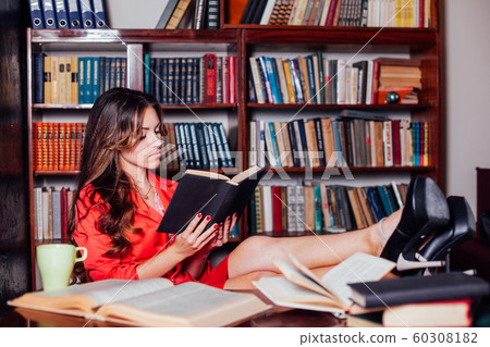 girl reading a book on the table legs girl reading a book on the table legs 60308182