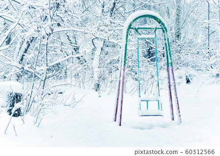 Children's swings in winter park Children's swings in winter park 60312566