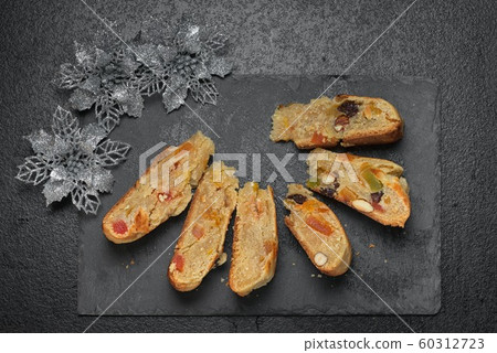 Stollen traditional Christmas cake made in a round 60312723