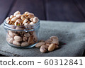 Pistachios in glass jars on a wooden background 60312841
