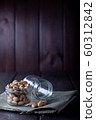 Pistachios in glass jars on a wooden background 60312842