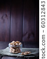 Pistachios in glass jars on a wooden background 60312843