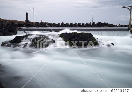 A stream of water flowing down roughly A stream of water flowing down roughly 60313967