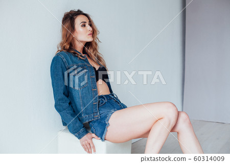 portrait of a beautiful fashionable woman in lingerie and denim shorts 60314009