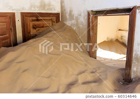 Abandoned and forgotten building and room left by people and being taken over by encroaching sandstorm, Kolmanskop ghost town, Namib Desert 60314646