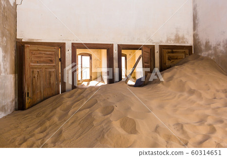 Abandoned and forgotten building and room left by people and being taken over by encroaching sandstorm, Kolmanskop ghost town, Namib Desert 60314651