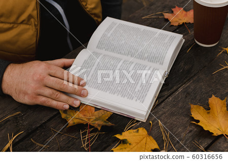 male female reads a book in autumn park drinks male female reads a book in autumn park drinks 60316656