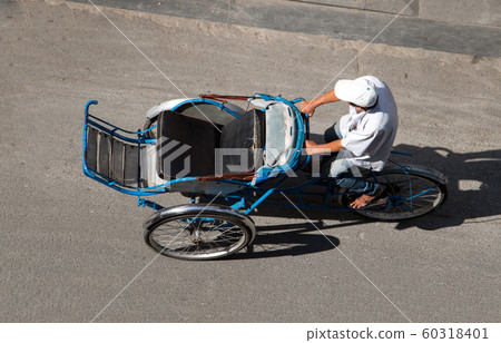 Man drive empty rickshaw - tricycle on the streets of Saigon, Vietnam. 60318401