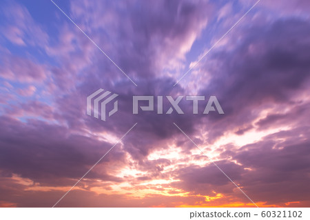 blue bright and orange yellow dramatic sunset sky 60321102