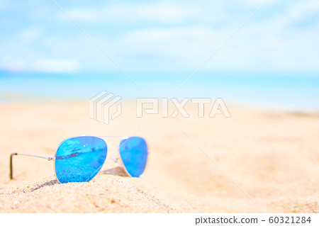 Sunglasses on the beach. Sunglasses on the beach. 60321284