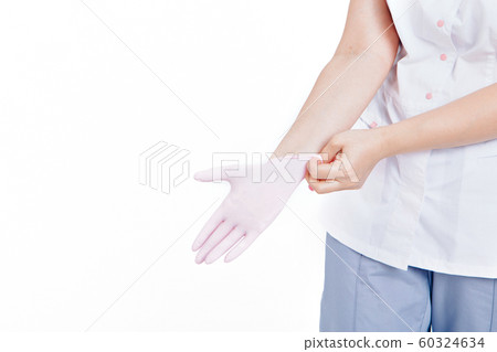 The doctor puts rubber gloves on his hand. the medic is preparing for surgery. Concept of medicine, medical instruments, healthcare. Isolated, copy space The doctor puts rubber gloves on his hand. the medic is preparing for surgery. Concept of medicine, medical instruments, healthcare. Isolated, copy space 60324634