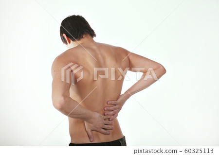 back pain: a man on a white background holding his sore torso back pain: a man on a white background holding his sore torso 60325113