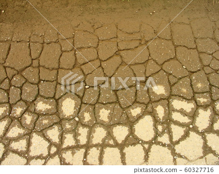Cracked road after rain Cracked road after rain 60327716