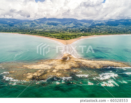 Aerial view National Park Punta Uvita Beautiful beach tropical forest pacific coast Costa Rica shape whale tail Aerial view National Park Punta Uvita Beautiful beach tropical forest pacific coast Costa Rica shape whale tail 60328553