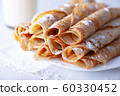 Fried pancakes rolled into a tube on a white 60330452