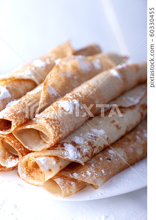Fried pancakes rolled into a tube on a white 60330455