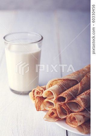 Fried pancakes rolled into a tube on a white 60330456