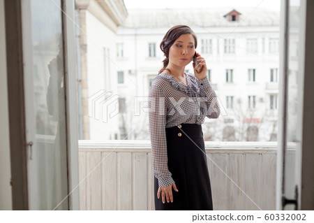 beautiful fashionable asian woman in a business suit at work in the office 60332002