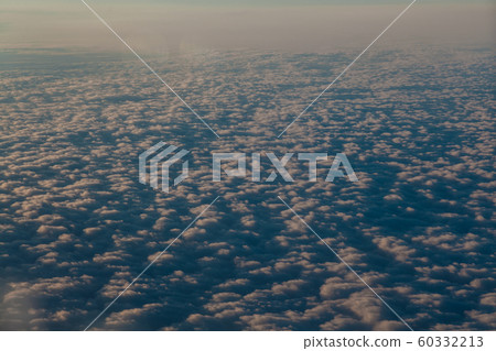 flying above the clouds at sunset landscape from an airplane flying above the clouds at sunset landscape from an airplane 60332213