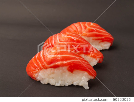 Salmon sushi on black background. Salmon sushi on black background. 60333035
