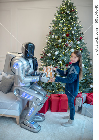 Robot and a cute girl exchanging christmas gifts Robot and a cute girl exchanging christmas gifts 60334040